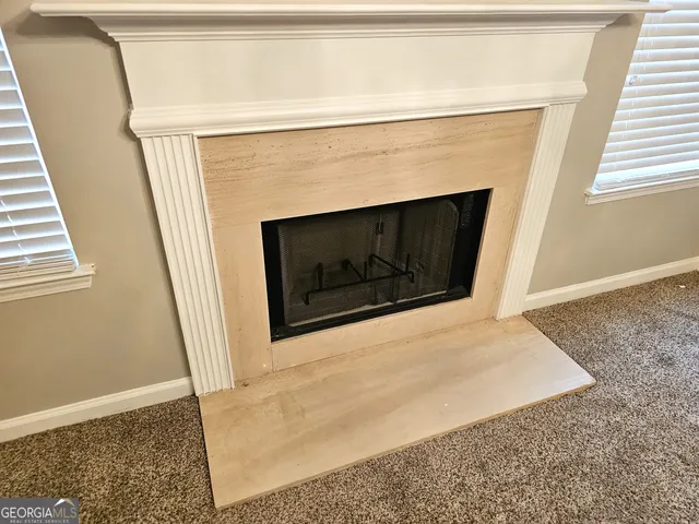 a kitchen with a stove a refrigerator and a fireplace