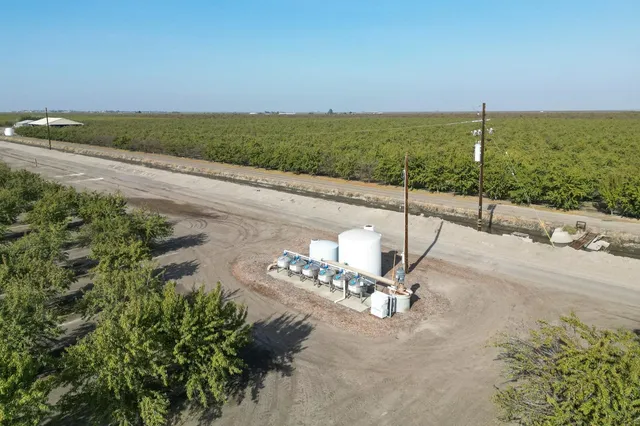 a view of a terrace with furniture and a garden