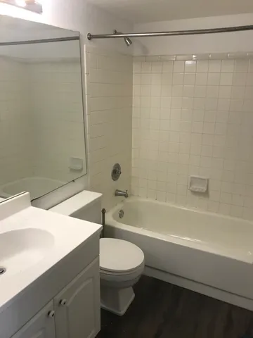 a bathroom with a toilet a sink and a shower