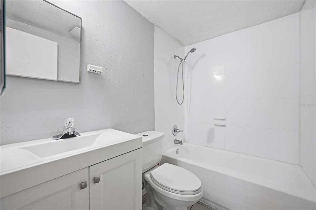 11733 North 12th Street, Unit G Tampa, FL 33612 - Photo 11 of 25 a bathroom with a sink toilet and shower