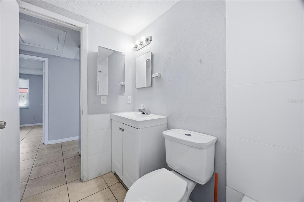 11733 North 12th Street, Unit G Tampa, FL 33612 - Photo 12 of 25 a white toilet sitting next to a bathroom sink