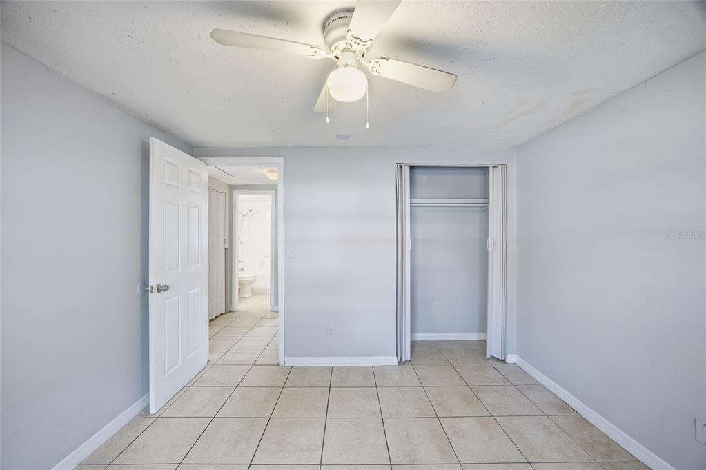 11733 North 12th Street, Unit G Tampa, FL 33612 - Photo 8 of 25 wooden floor in an empty room with a window