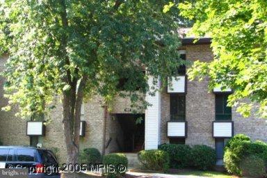 11617 Stoneview Square, Unit 1B Reston, VA 20191 - Photo 1 of 1 a view of a brick house with a tree