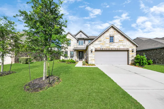 a front view of a house with a yard and garage