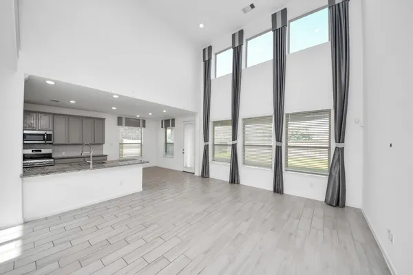 a view of a kitchen with a sink and a large window
