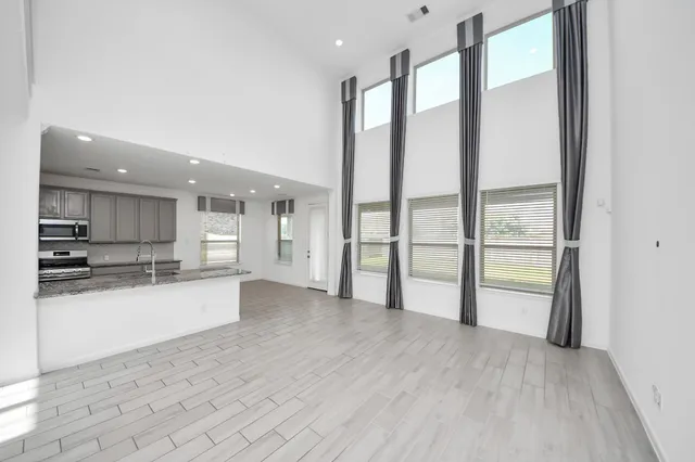 a view of a kitchen with a sink and a large window