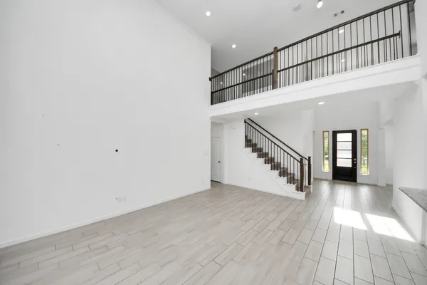 wooden floor in a hall with a window and wooden floor