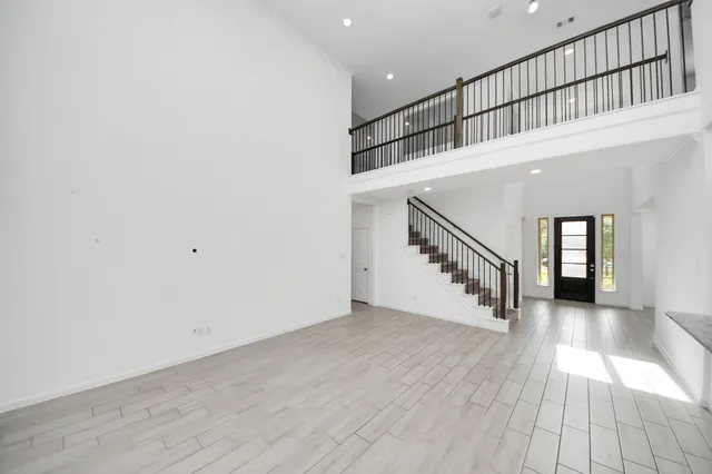 wooden floor in a hall with a window and wooden floor