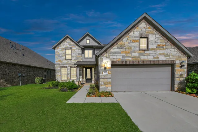 a front view of a house with a yard and garage