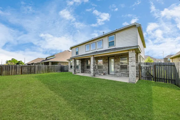 a view of a house with a yard and sitting area