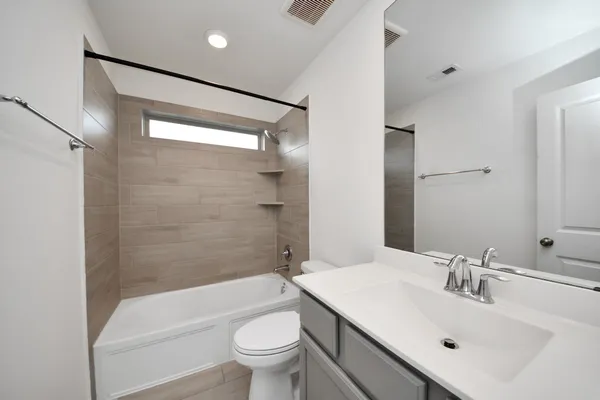 a bathroom with a sink mirror toilet and bathtub