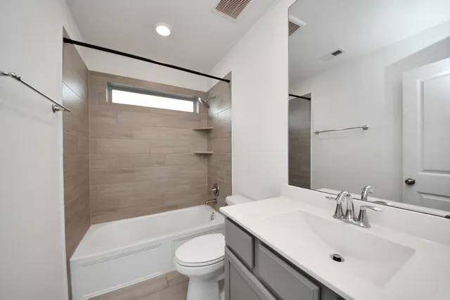 a bathroom with a sink mirror toilet and bathtub