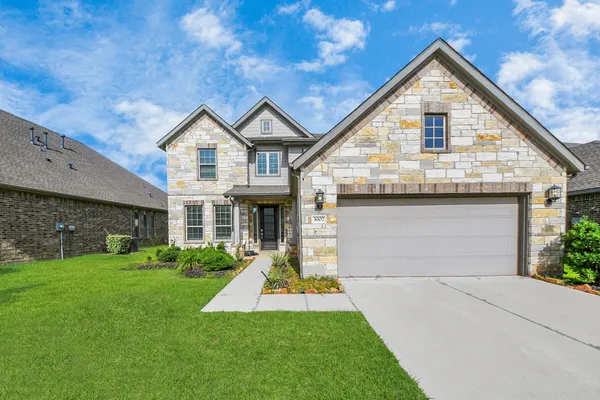 a front view of house with yard and green space