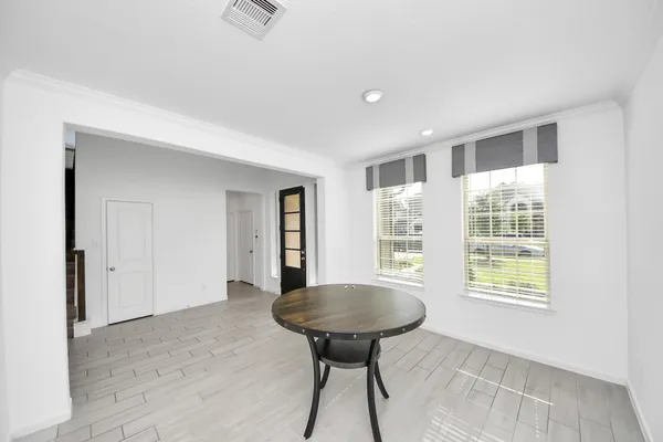 a view of a room with a bathtub windows and wooden floor