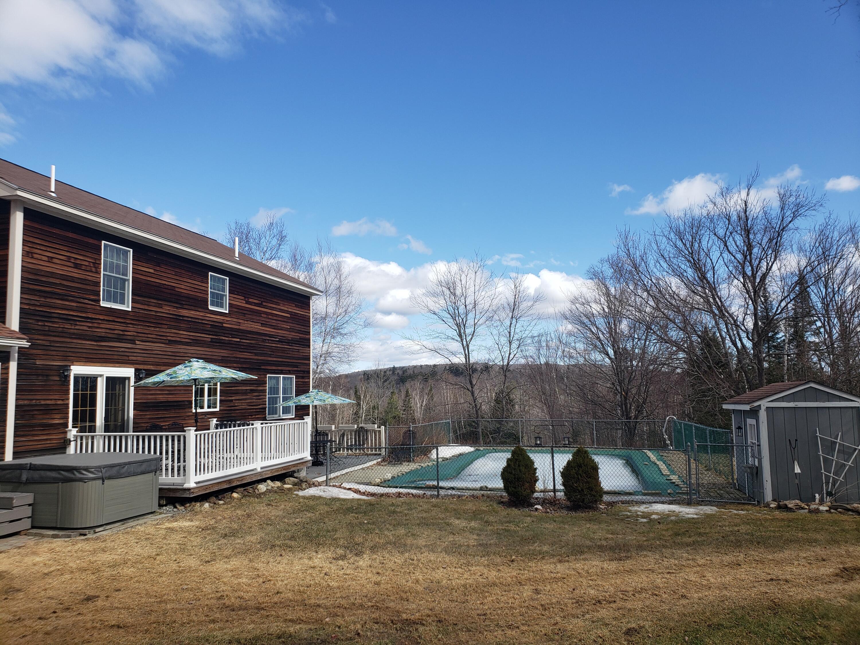 647 Franklin Road Jay, ME 04239 - Photo 4 of 73 Showing back deck & 18x36 inground pool.