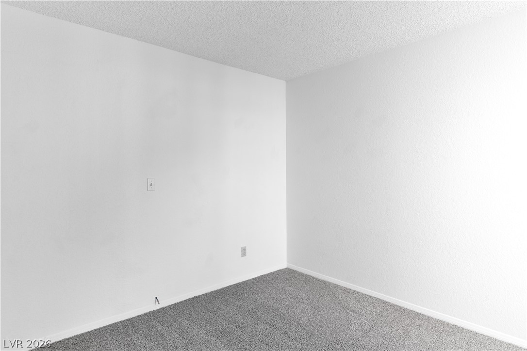2146 High Dunes Lane Laughlin, NV 89029 - Photo 19 of 64 Third bedroom featuring carpet, a textured ceiling, and baseboards