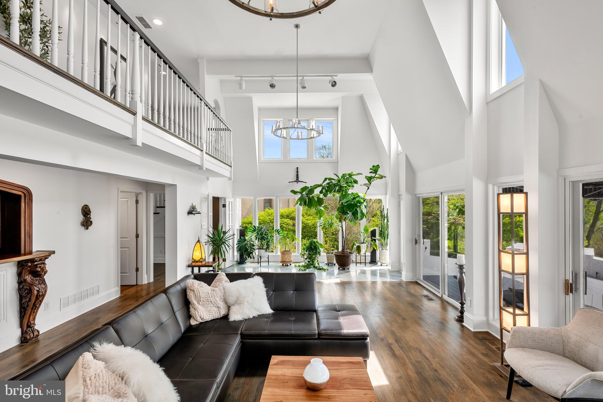 238 Ravenscliff Road Wayne, PA 19087 - Photo 16 of 74 a living room with furniture a chandelier and wooden floor