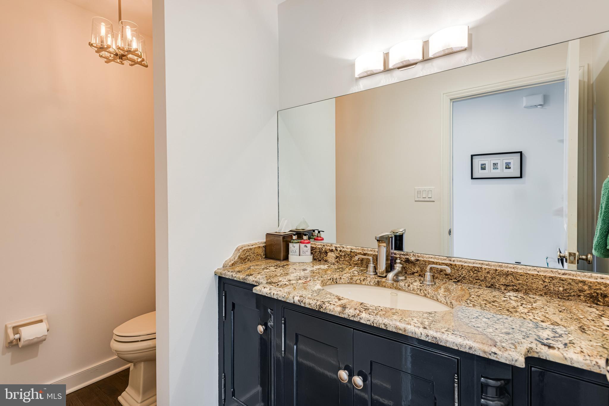 238 Ravenscliff Road Wayne, PA 19087 - Photo 36 of 74 a bathroom with a granite countertop sink and a mirror