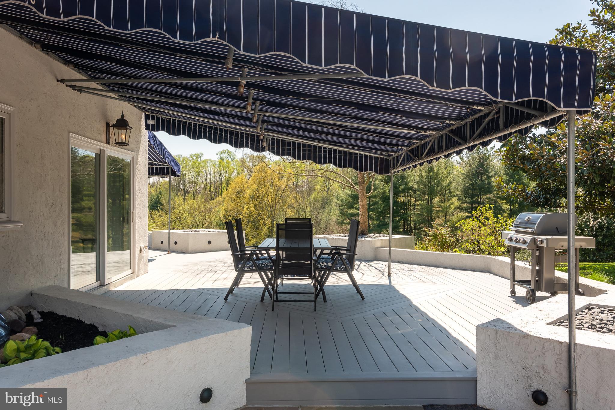 238 Ravenscliff Road Wayne, PA 19087 - Photo 61 of 74 a patio with wooden floor a yard a table and chairs