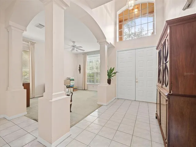 an empty room with a ceiling fan and a window