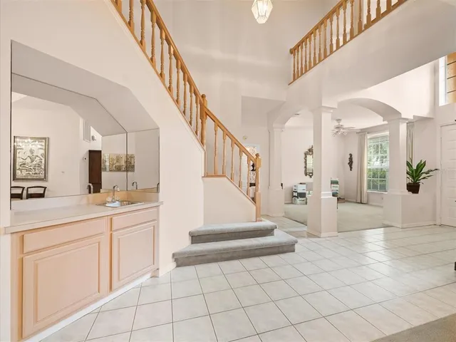 a kitchen with a refrigerator a sink and cabinets