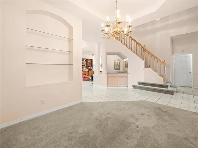 a living room with furniture and large windows