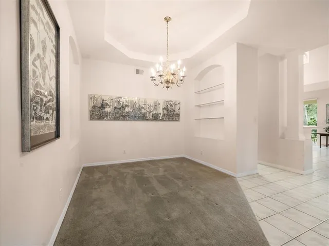 a living room with furniture a rug and a chandelier