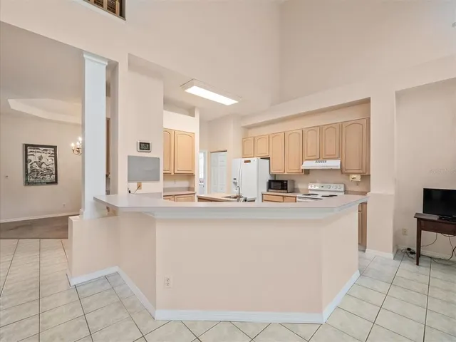 a view of a hallway with wooden floor and windows