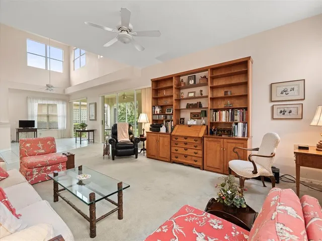 a bedroom with a bed and a ceiling fan