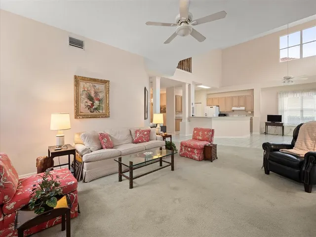 a bedroom with a bed and a ceiling fan