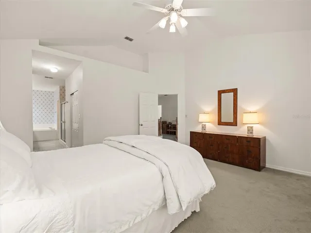 an aerial view of residential houses with outdoor space and lake view