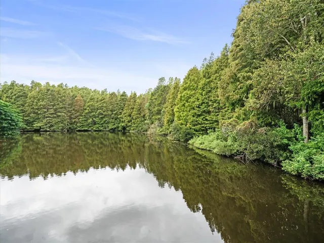 a view of an empty room with stairs and a ceiling fan