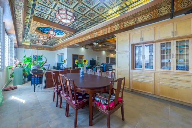 a dining room with furniture and a floor to ceiling window
