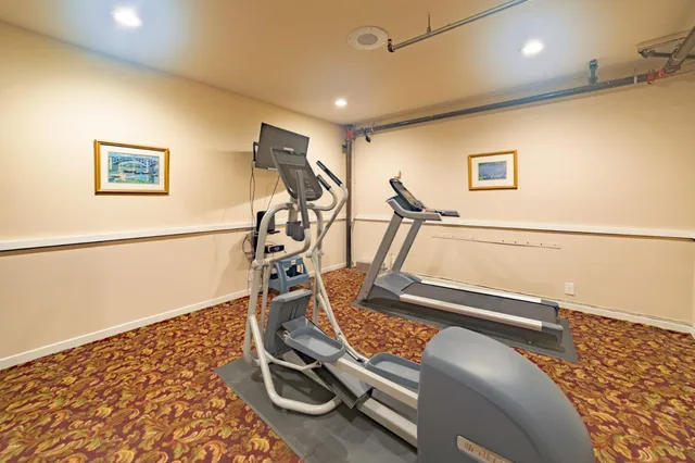 a view of hallway with a bathroom