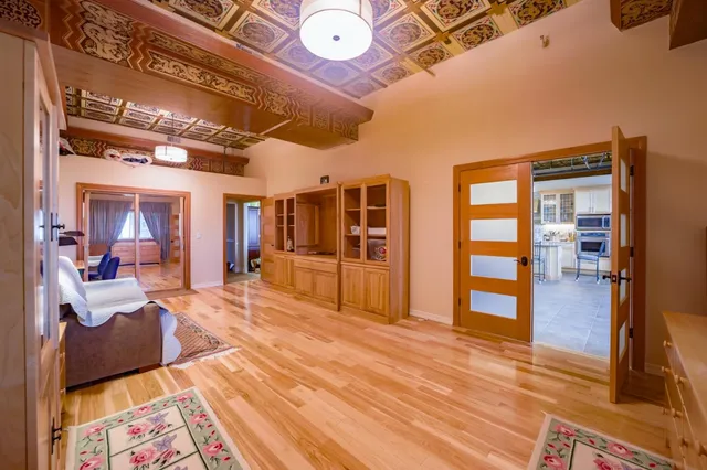 a view of a room with wooden floor and furniture
