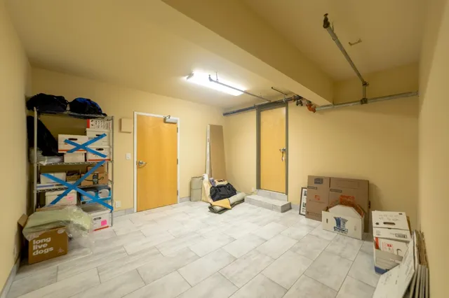 a bedroom with a bed a table and chair