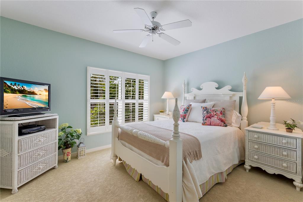 760 Seaboard Line Lane Boca Grande, FL 33921 - Photo 12 of 71 a bedroom with a bed and a flat screen tv