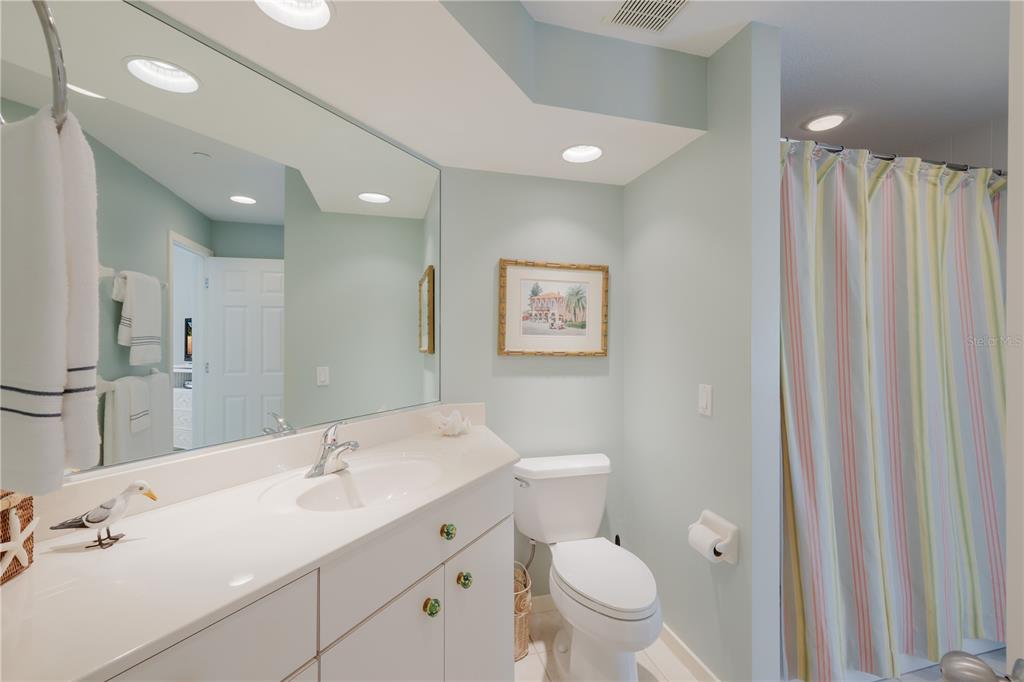 760 Seaboard Line Lane Boca Grande, FL 33921 - Photo 13 of 71 a bathroom with a toilet a sink a mirror and a shower