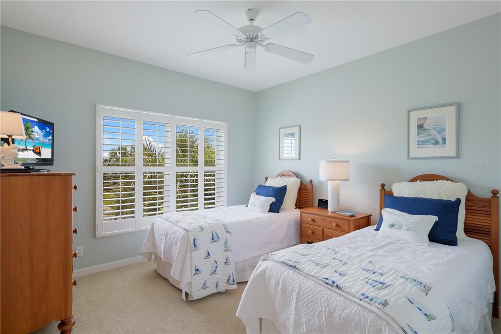 760 Seaboard Line Lane Boca Grande, FL 33921 - Photo 15 of 71 a bedroom with two beds and a large window