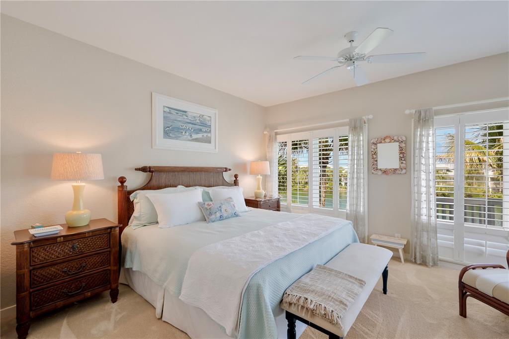 760 Seaboard Line Lane Boca Grande, FL 33921 - Photo 17 of 71 a bedroom with a large bed and a couch