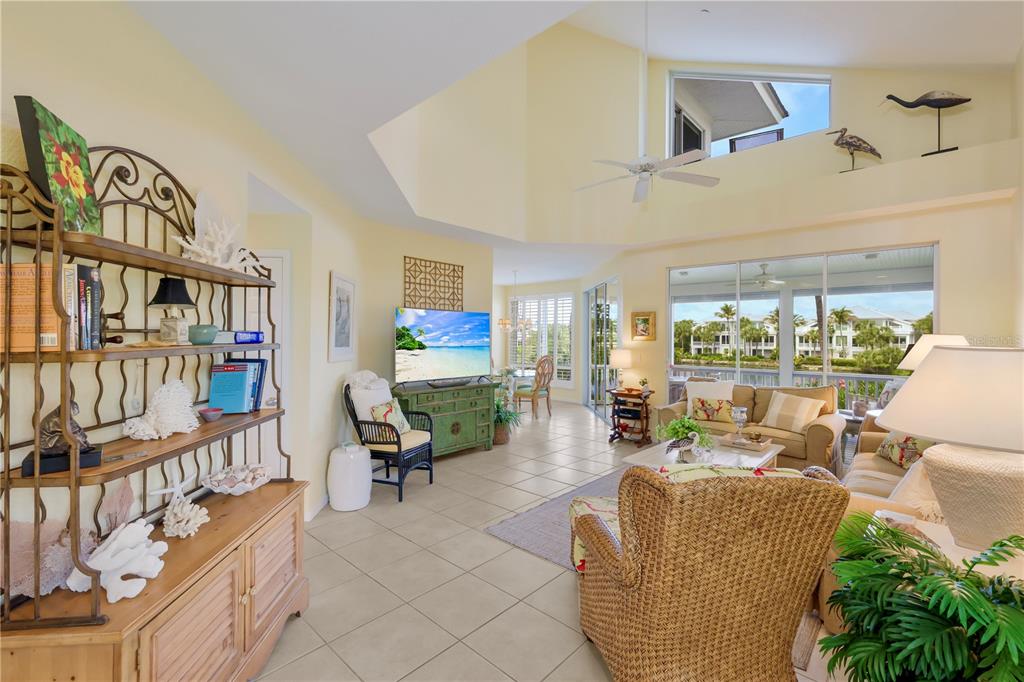 760 Seaboard Line Lane Boca Grande, FL 33921 - Photo 3 of 71 a living room with fireplace furniture and a book shelf