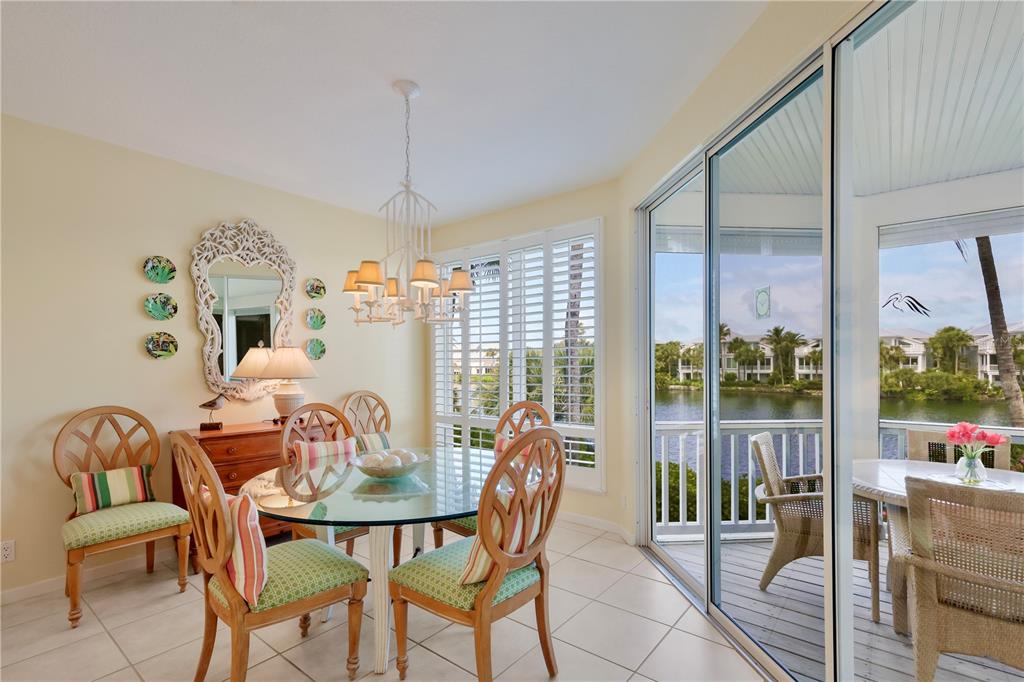 760 Seaboard Line Lane Boca Grande, FL 33921 - Photo 8 of 71 a dining room with furniture a chandelier and glass door
