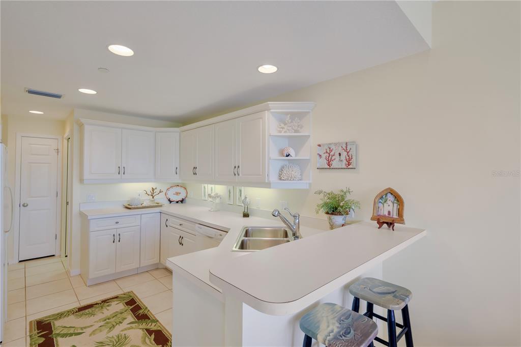 760 Seaboard Line Lane Boca Grande, FL 33921 - Photo 9 of 71 a kitchen with a sink a stove and cabinets