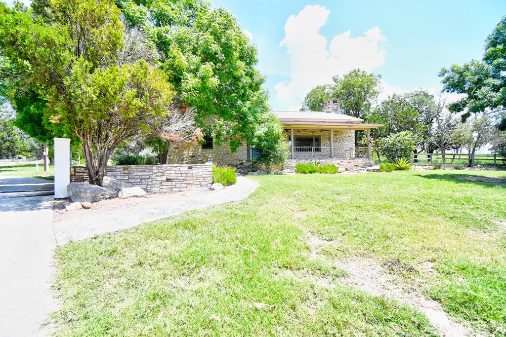 155 B Nimitz Road Kerrville, TX 78028 - Photo 1 of 30 a view of a backyard with a garden and trees