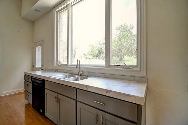 a kitchen with a sink and a window