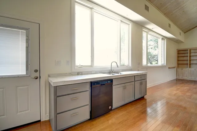 a bathroom with a granite countertop sink and a large mirror
