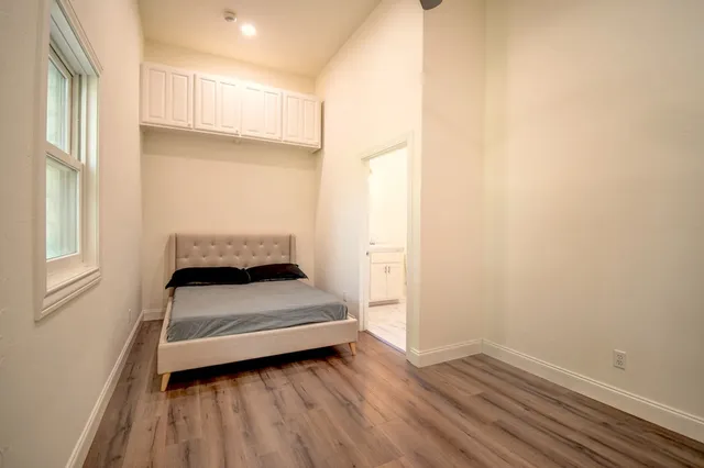 a bedroom with a bed and a window