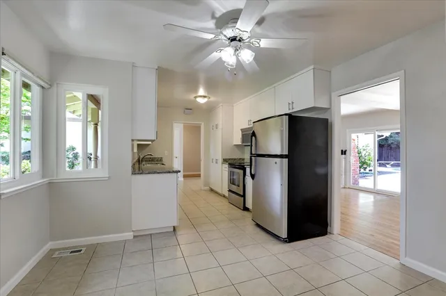 a kitchen with a refrigerator a sink and cabinets