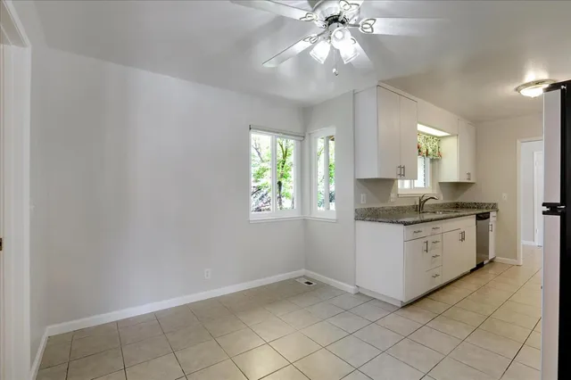 a kitchen with a cabinets window and stainless steel appliances