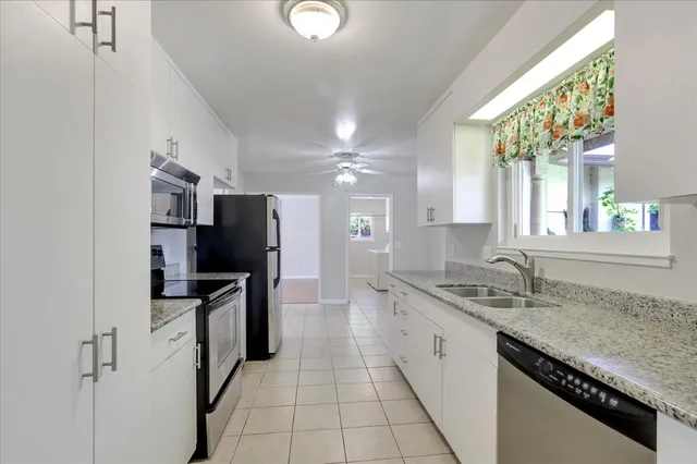 a kitchen with stainless steel appliances granite countertop a sink stove and refrigerator